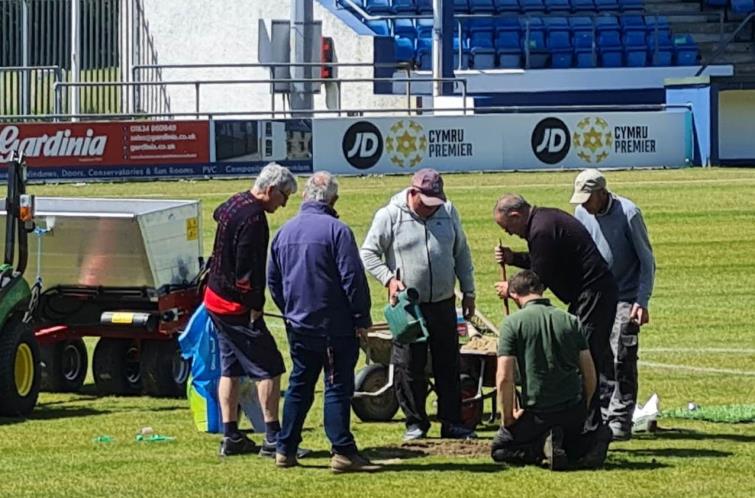 Alan Thomas and ground staff repair the surface Alan Thomas and ground staff repair the surface